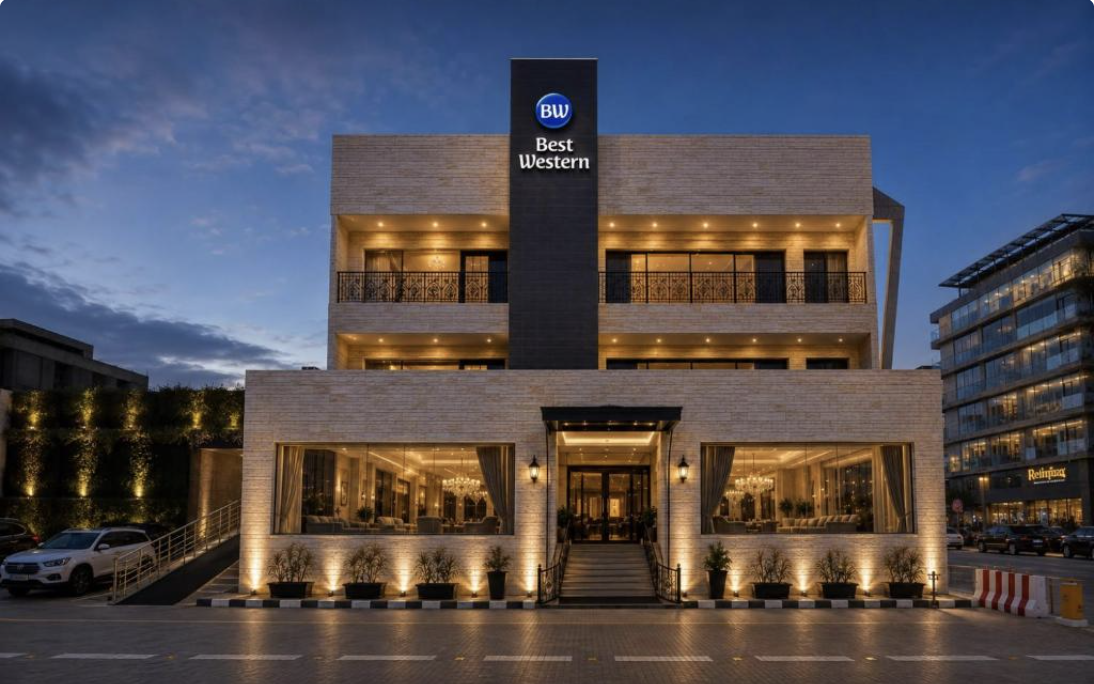 Illuminated stone facade of Best Western Faisalabad at dusk